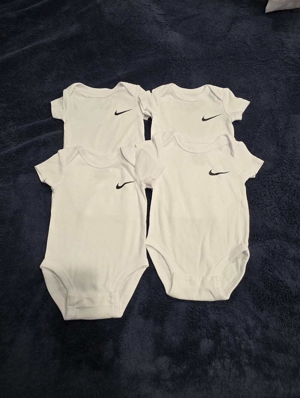 Nike White Baby Bodysuit Set with Black Swoosh - 4 Pack
